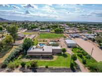 Expansive aerial view of a ranch home with a pool, large yard, and scenic mountain views at 26232 S Lemon Ave, Queen Creek, AZ 85142