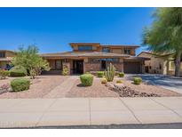 Charming two-story home with well-maintained desert landscaping and brick accents at 30277 N 125Th Ln, Peoria, AZ 85383