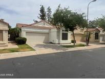 Charming single-story home featuring a tile roof, attached garage, and well-maintained landscaping at 3440 E Southern Ave # 1107, Mesa, AZ 85204