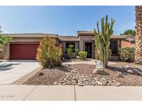 Charming home featuring a beautifully landscaped front yard with desert plants and decorative rock at 42310 W Fountainhead St, Maricopa, AZ 85138