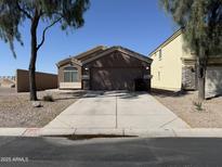 Charming single-story home with a well-maintained front yard and attached two-car garage at 43213 W Cowpath Rd, Maricopa, AZ 85138