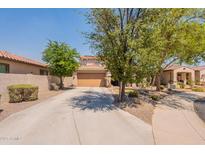 Charming home with a two-car garage and desert landscaping at 7169 S Dodane Ct, Gilbert, AZ 85298