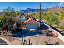 Desert home with a clay tile roof, two-car garage, and mountain views in a beautiful setting at 8950 E Greenview Dr, Gold Canyon, AZ 85118