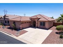 Charming single-story home featuring a beautiful tile roof, neutral stucco and a spacious driveway in a well maintained community at 9175 E Rainier Dr, Gold Canyon, AZ 85118
