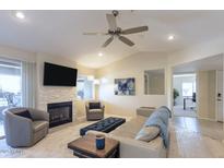 Bright living room with fireplace, ceiling fan, and neutral decor for a relaxing atmosphere at 9745 N 95Th St # 227, Scottsdale, AZ 85258