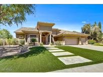 Elegant single-story home featuring a lush lawn, stone pathway, and a neutral color palette at 1092 N Roosevelt Ave, Chandler, AZ 85226