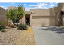 Charming single-story home featuring a well-maintained yard, two-car garage, and desert landscaping at 11762 E Becker Ln, Scottsdale, AZ 85259