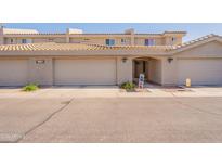 Inviting townhouse exterior with desert landscaping, garage, and covered entryway with block wall construction at 16021 N 30Th St # 122, Phoenix, AZ 85032