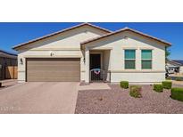 Inviting single-story home featuring a neutral color palette and a well-manicured front yard at 17506 W Hadley St, Goodyear, AZ 85338