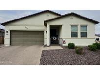 Charming single-story home with desert landscaping, a two-car garage, and a welcoming front porch at 17506 W Hadley St, Goodyear, AZ 85338