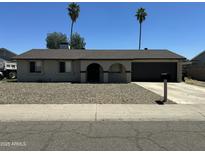 Charming single-story home featuring a gravel front yard and a two-car garage, perfect for suburban living at 2007 N 55Th Ln, Phoenix, AZ 85035