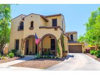 Two-story home with arched porch, neutral stucco, desert landscaping, and attached garage in a sunny setting at 20639 W Grandview Dr, Buckeye, AZ 85396