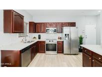 Modern kitchen with stainless steel appliances and dark wood cabinetry offers a stylish design at 2402 E 5Th St # 1498, Tempe, AZ 85288