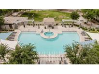 Aerial view of a sparkling pool and hot tub surrounded by lush landscaping and inviting seating areas at 2402 E 5Th St # 1498, Tempe, AZ 85288