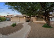 Charming home with a well-manicured front yard, three-car garage and lovely walkway leading to the front door at 2434 S Colleen Sw --, Mesa, AZ 85210