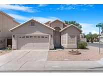 Charming single-Gathering home with a two-car garage, desert landscaping, and a welcoming front entrance at 254 W Amoroso Dr, Gilbert, AZ 85233