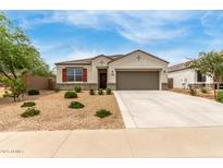 Charming single-story home with a well-maintained landscape and a two-car garage at 30390 W Mitchell Ave, Buckeye, AZ 85396