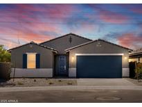 Charming single-story home with a well-manicured front yard and a two-car garage at 37357 W San Sisto Ave, Maricopa, AZ 85138