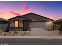 Inviting single-story home with a brick driveway, two-car garage, and desert landscaping at 4226 W Lisa Ln, San Tan Valley, AZ 85144