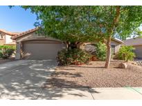 Charming single-story home with a well-manicured front yard and a two-car garage at 43121 W Sunland Dr, Maricopa, AZ 85138