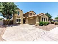 Inviting two-story home with a spacious driveway, neutral exterior, and well-maintained landscaping at 4322 S Ranger Trl, Gilbert, AZ 85297
