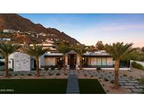 Stunning exterior showcasing the home's modern design, desert landscape, and mountain views in the background at 4763 N 53Rd St, Phoenix, AZ 85018