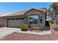 Charming single-story home featuring a tiled roof, a two-car garage, and desert landscaping at 6610 E University Dr # 165, Mesa, AZ 85205