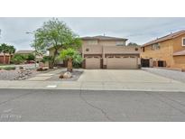 Two-story home featuring a three-car garage and desert landscaping at 6833 W Tether Trl, Peoria, AZ 85383