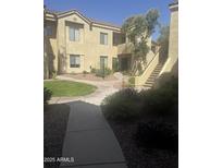 Inviting condo exterior with landscaped courtyard, providing a serene and welcoming atmosphere at 7575 E Indian Bend Rd # 1100, Scottsdale, AZ 85250
