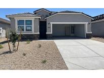 Charming single-story home featuring neutral tones, stone accents, a two-car garage, and a neatly landscaped front yard at 1331 S Vista Ave, Florence, AZ 85132
