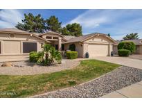 Charming single-story home with desert landscaping, lush greenery, and a two-car garage at 13731 W Greenview Dr, Sun City West, AZ 85375