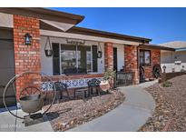 Charming home featuring a quaint front patio, brick accents, and desert landscaping at 228 N 65Th Pl, Mesa, AZ 85205