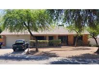 Charming single-story home with mature trees and a well-maintained xeriscaped front yard at 2320 W El Alba Way, Chandler, AZ 85224