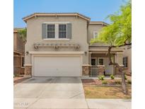 Charming two-story home featuring a two-car garage and inviting front yard landscaping at 2331 E Sunland Ave, Phoenix, AZ 85040