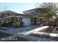 Beautiful two story home featuring a manicured front yard and an attached two car garage at 26022 N Sandstone Way, Surprise, AZ 85387