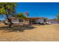 Charming single-story home with a welcoming front porch and a spacious front yard at 3738 E Hash Knife Draw Rd, Queen Creek, AZ 85140