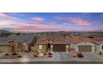 Charming home with desert landscaping, stone accents, and a tile roof under a lovely sky at 40990 W Agave Rd, Maricopa, AZ 85138