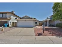 Charming single-story home featuring a two-car garage, well-maintained driveway and low maintenance landscaping at 4445 W Oraibi Dr, Glendale, AZ 85308