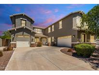 Stunning two-story home with dual garages, stone accents, and a charming tiled roof at 6235 S Odessa Dr, Gilbert, AZ 85298