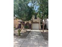 Inviting two-story home featuring a well-manicured lawn and a private two-car garage at 6339 W Sophie Ln, Laveen, AZ 85339