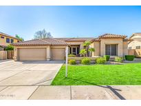 Charming single-story home featuring a well-manicured lawn, three-car garage, and tile roof at 6808 W Angela Dr, Glendale, AZ 85308