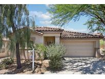 Inviting home with a tile roof, two-car garage, and desert landscaping at 7500 E Deer Valley Rd # 132, Scottsdale, AZ 85255