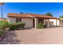 Inviting single-story home featuring a well-kept front yard with desert landscaping and a covered front entry at 815 W El Prado Rd, Chandler, AZ 85225
