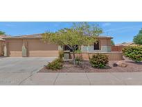 Charming single-story home with a well-maintained front yard and a two-car garage at 8210 W Wethersfield Rd, Peoria, AZ 85381
