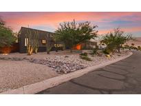 Striking contemporary home featuring desert landscaping and a unique architectural design at dusk at 9502 N 47Th St, Phoenix, AZ 85028