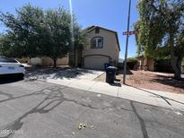 Charming two-story home featuring a neutral color palette, attached garage and well-maintained landscaping at 13265 W Watson Ln, Surprise, AZ 85379