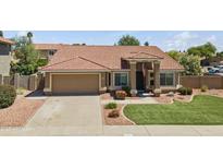 Charming single-story home with a well-manicured lawn, lovely landscaping, and a welcoming facade at 15011 S 27Th Pl, Phoenix, AZ 85048