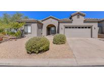 Inviting single-story home with a well-maintained desert landscape and a two-car garage at 15806 N 107Th Pl, Scottsdale, AZ 85255
