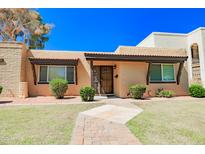 Charming single story home featuring a well-manicured lawn and inviting front walkway at 1726 W Claremont St, Phoenix, AZ 85015