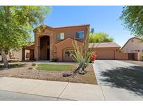 Inviting two-story home with a stone archway, tile roof, desert landscaping, and a wide driveway at 20271 E Appaloosa Dr, Queen Creek, AZ 85142